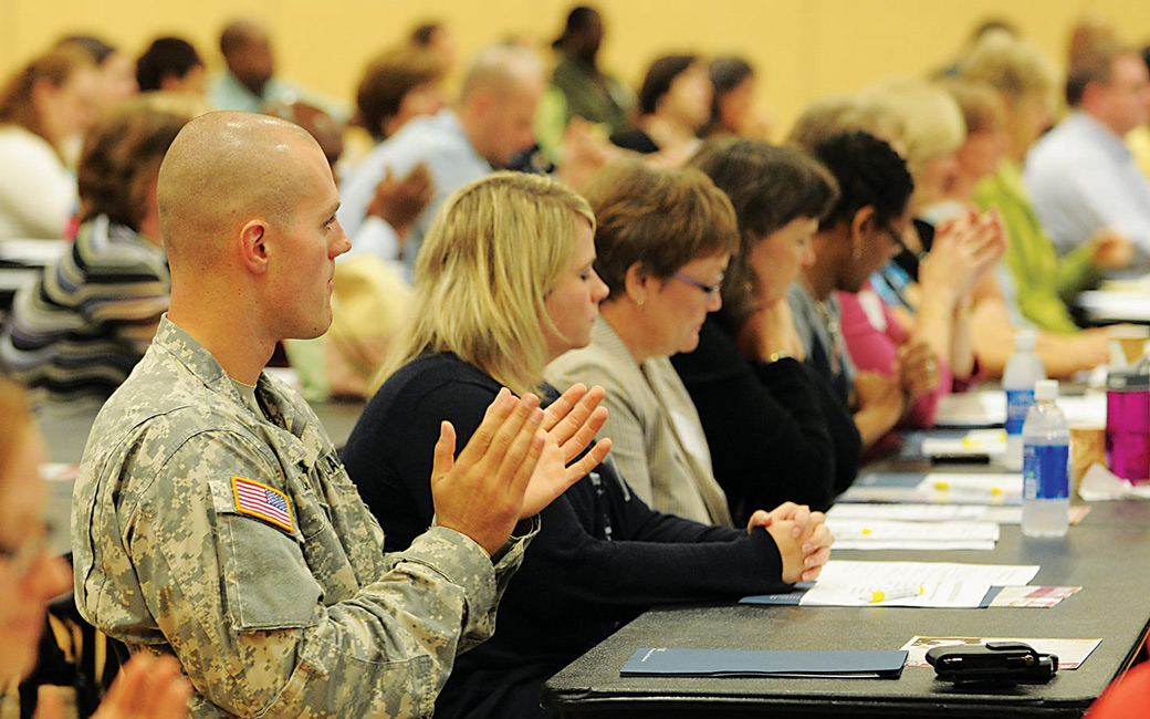 Veteran student clapping at conference