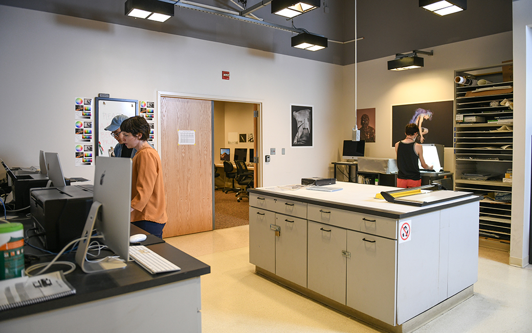 photography print center printers, computers, a faculty member with a student