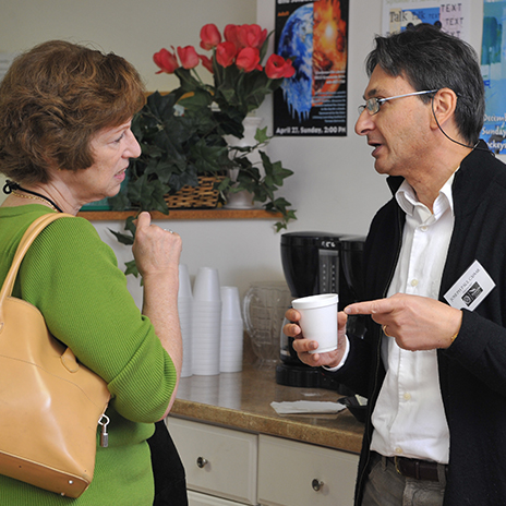 Male and Female Osher members talking over coffee