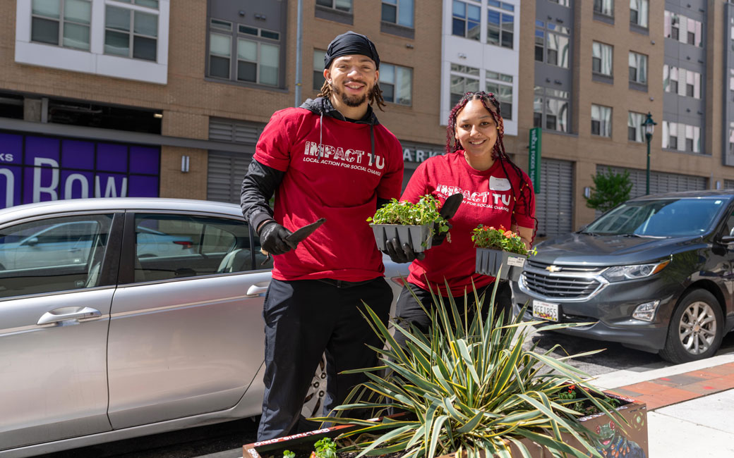 Students prepare to rehome plants in artful planters