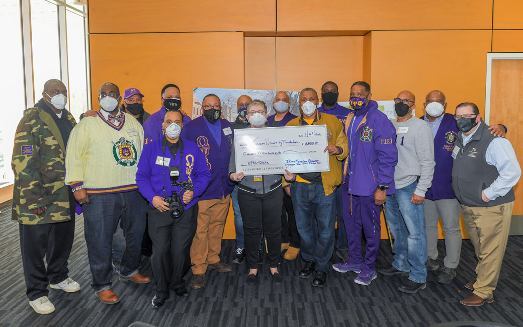 President Schatzel with members of the Omega Psi Phi fraternity