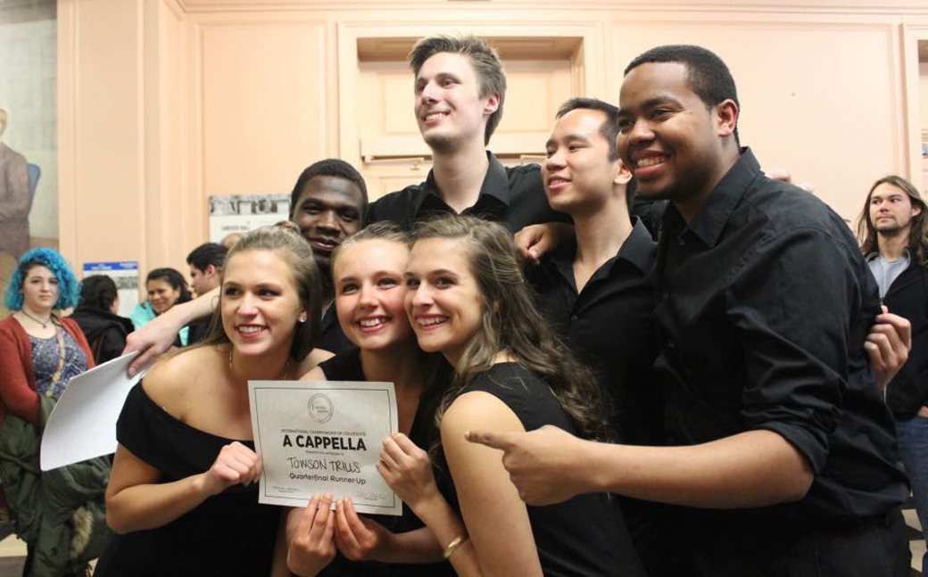 Members of the Towson University student a capella group the Towson Trills, celebrate after finishing second in the International Championship of Collegiate A Cappella Mid-Atlantic Quarterfinal at Johns Hopkins University on Feb. 25. 