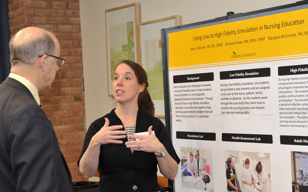 faculty presenting a poster