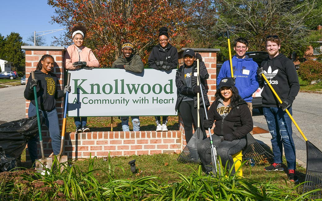 Students do yard work in a local community.