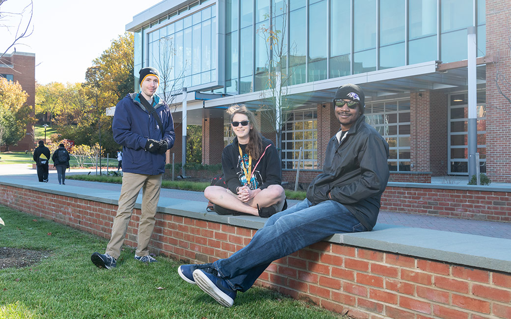 Group of students talking and sitting in tront of the University Union