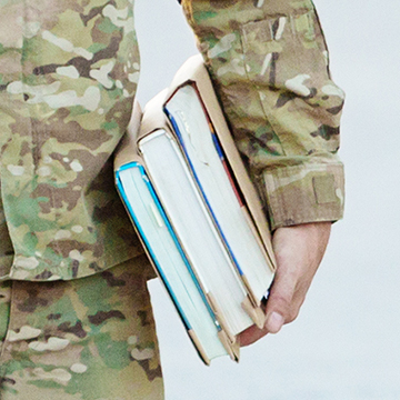 close-up of military person with books