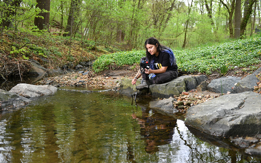 Student collecting water sample