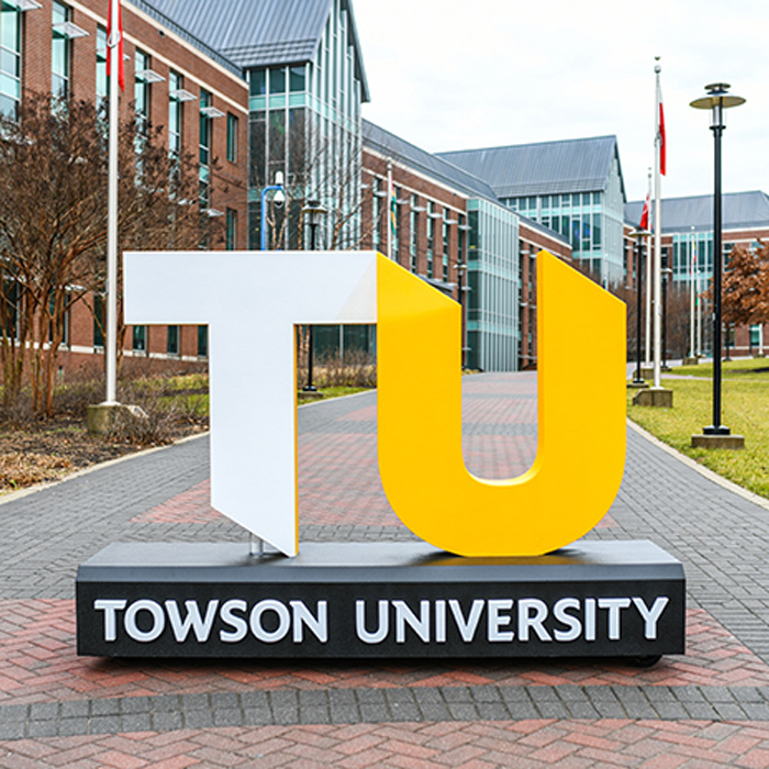TU logo sculpture on sidewalk near Liberal Arts building
