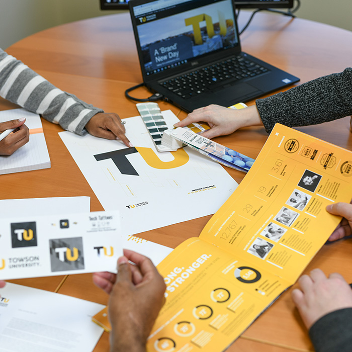 TU employees examining branded material