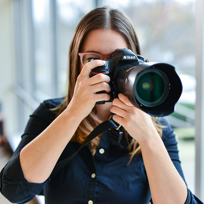 university photographer with camera