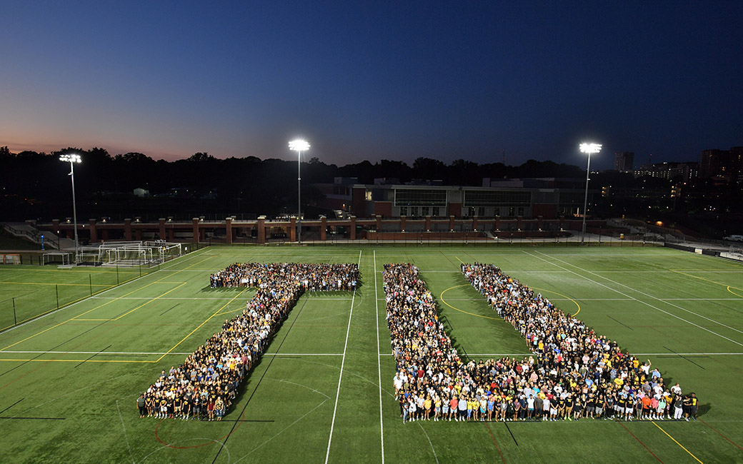 Students on the TU football field in the shape of a T and U