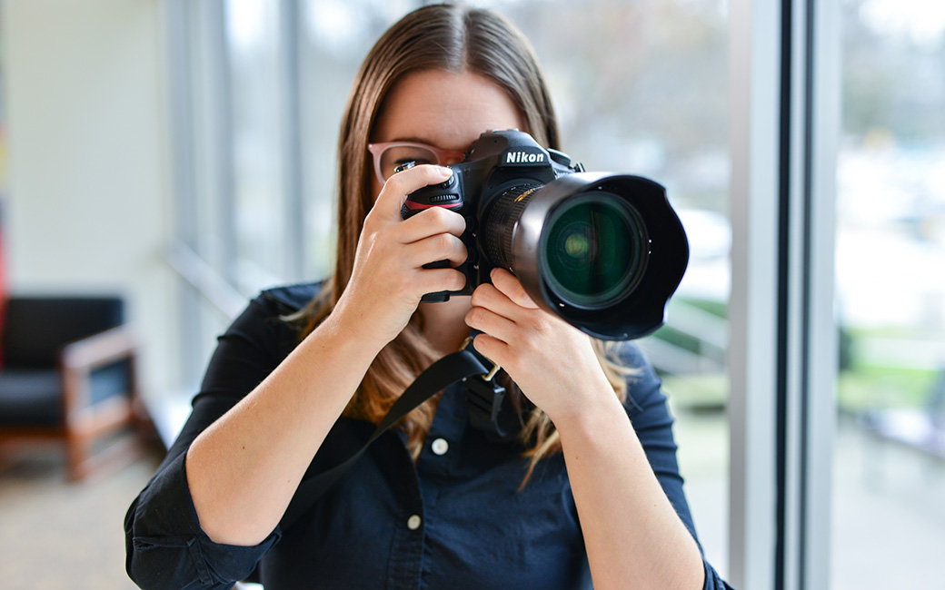 TU staff photographer with camera