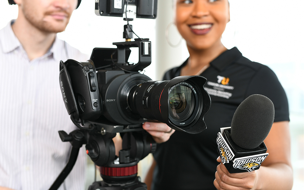 TU staff with video camera and microphone