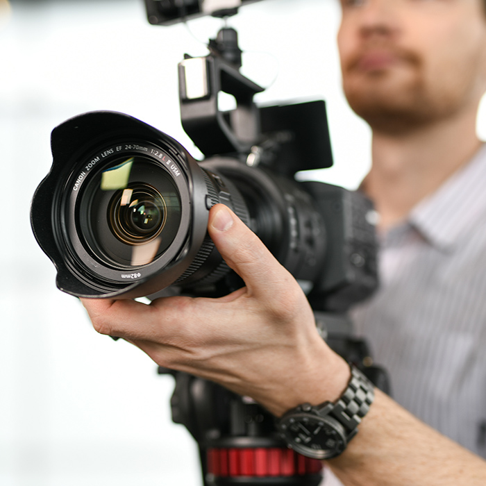 TU videographer holding video camera