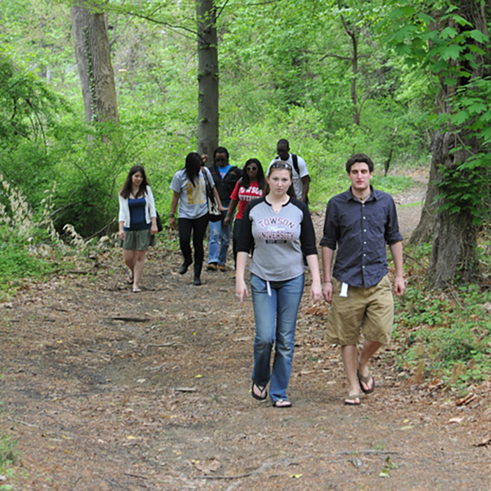 Student walking in the Glen Arboretum
