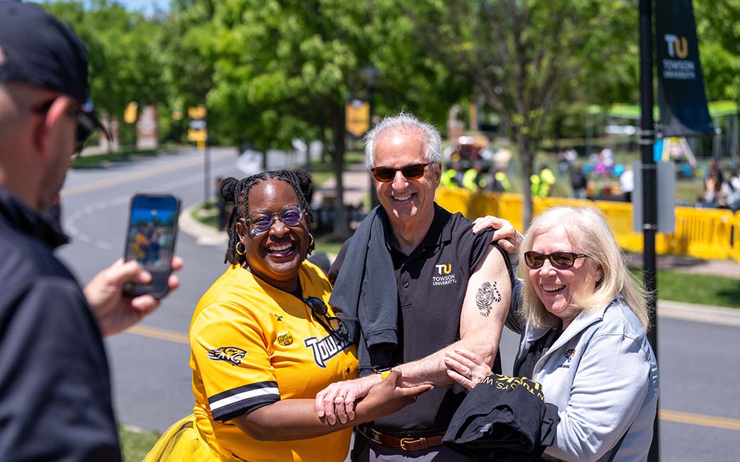 President Ginsberg with a tiger tattoo and others dressed in TU gear