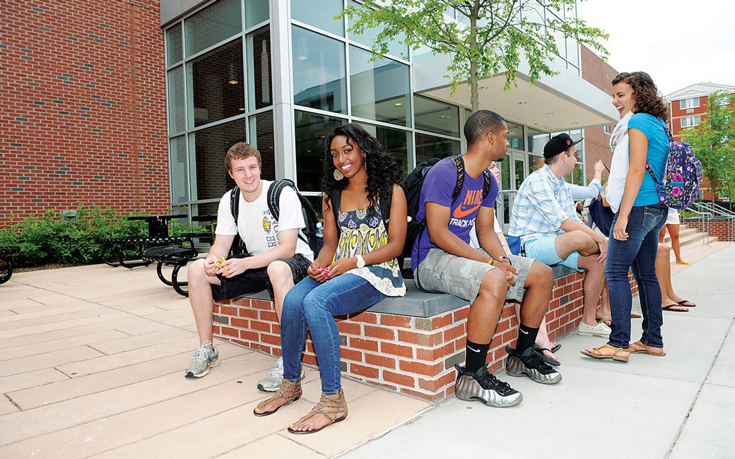 Group of students sitting outside of West Village Commons