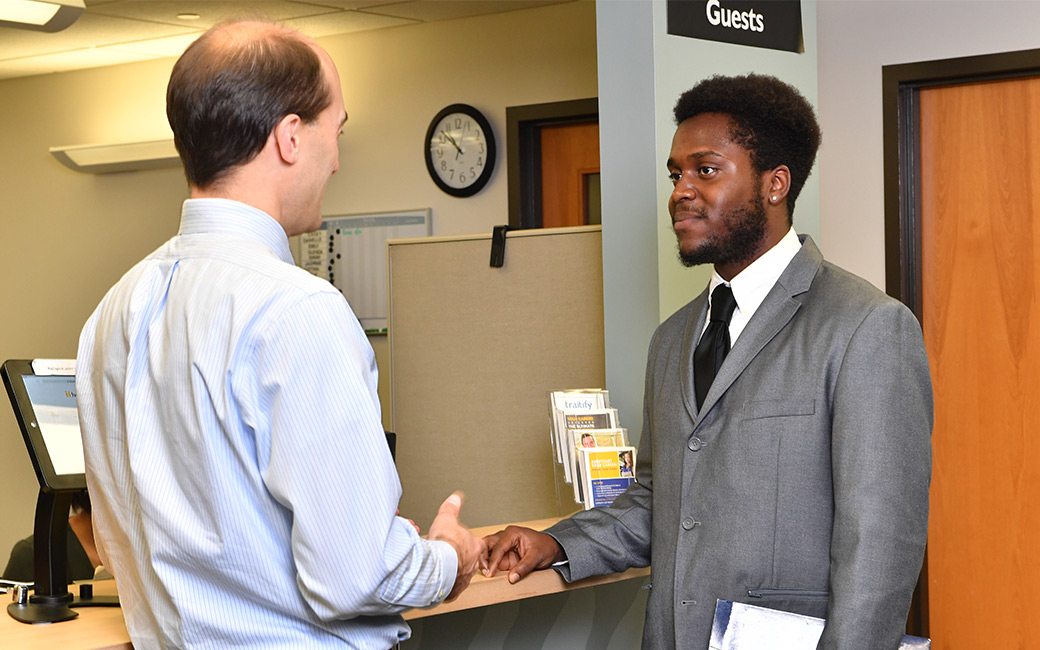 Staff member and student talking