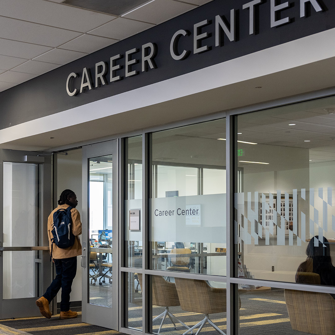 Student walking into Career Center through front door