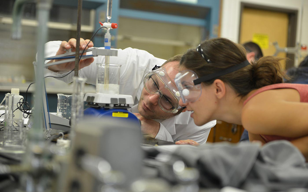 Student working with professor in lab