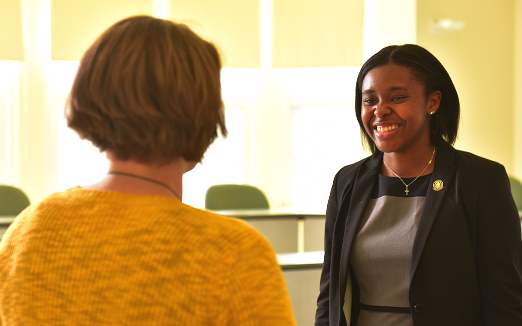 Accounting student and KPMG intern Breonna Myers talks to a professor