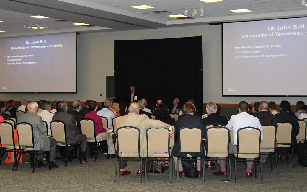 Attendees watch Dr. John Bell's presentation on game-changing trends in supply chain management at the 2014 event. 