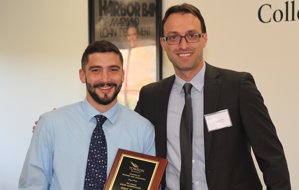 Winner Corey Barnard (left) with CBE associate professor and event organizer Plamen Peev.