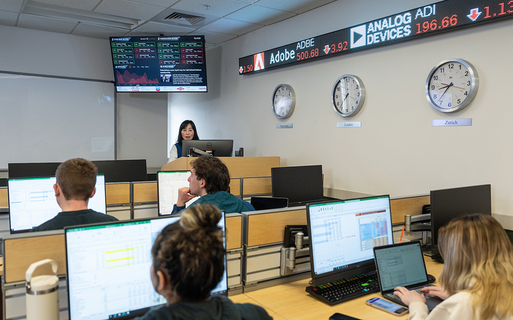 Finance professor teaches students in finance lab