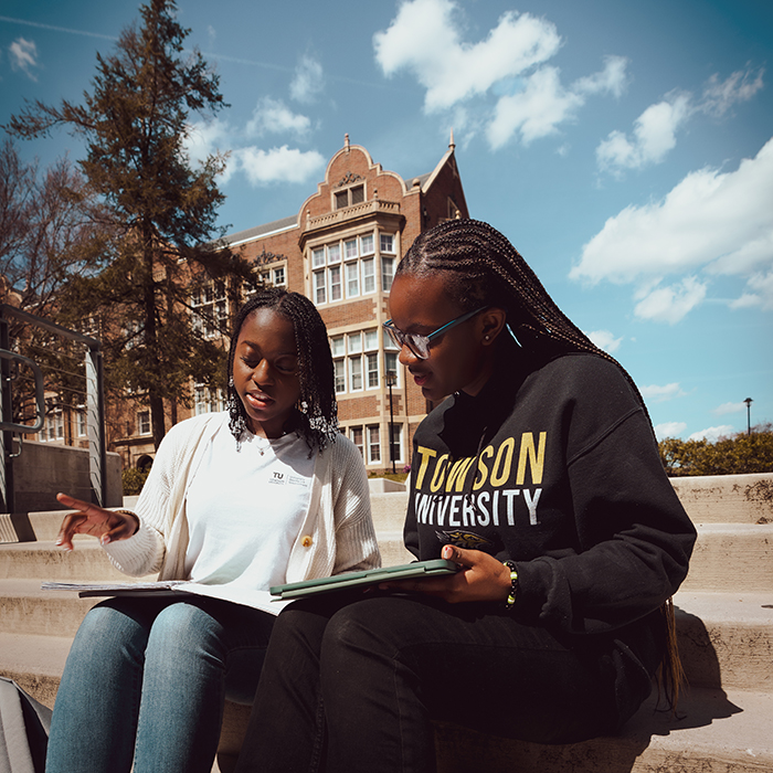 two students sitting on steps on the TU campus together