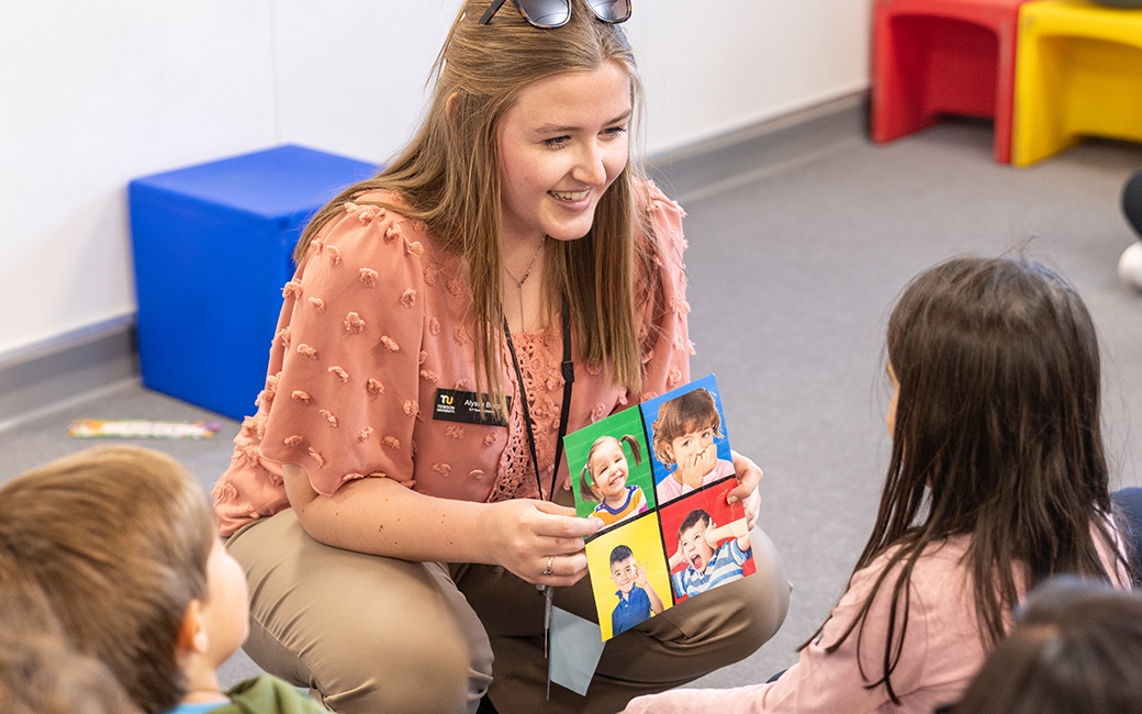 student helps child identify emotions with image