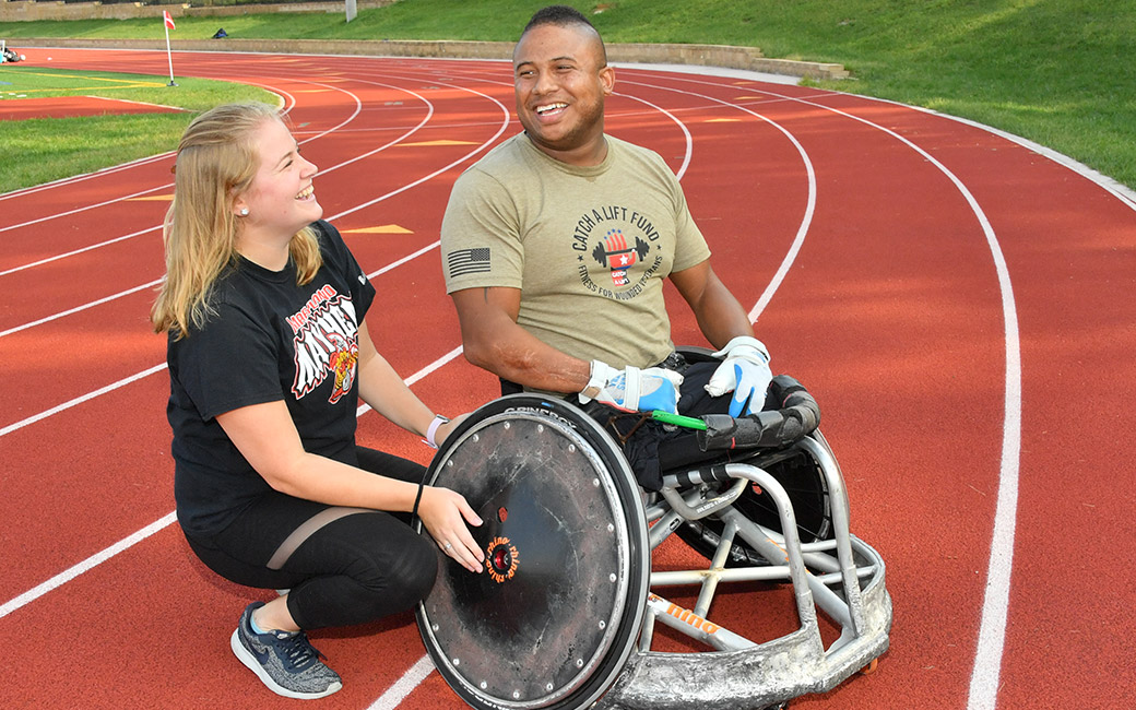 Erin Kissel works with rugby wheelchair athlete Ryan Major
