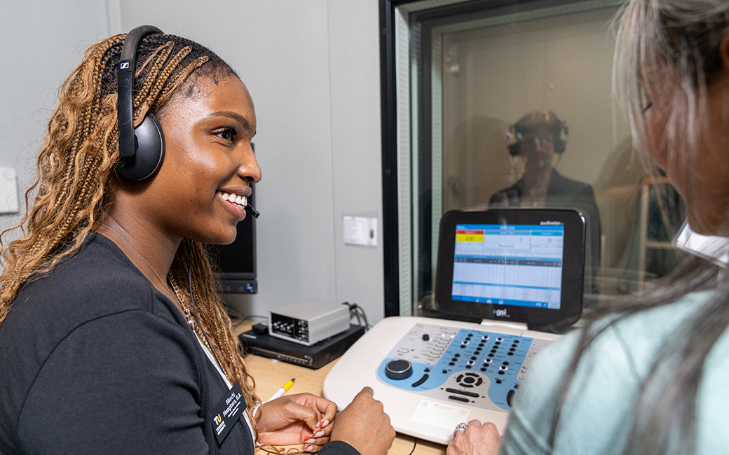 Student working with client in sound booth