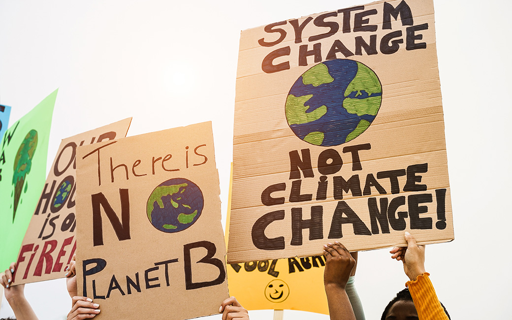people holding up climate change protest signs