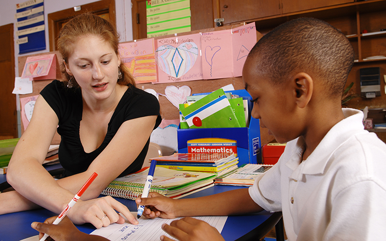 TU student teaching a child