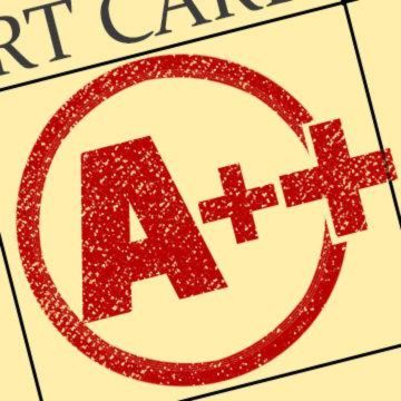 A++ Improv comedy troupe A++ Improv comedy troupe logo: A close-up view of an academic grading paper showing a top mark. A large, red ink stamp displaying the letter grade A followed by two plus signs sits inside a hand-drawn red circle. The stamp has a textured, slightly speckled appearance. The underlying paper is light yellow with thin black grid lines, and the partial text RT CAR appears in capital letters along the top border.