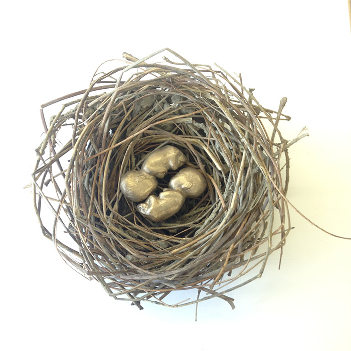 student sculpture of birds nest with 2 small bronze human fetuses