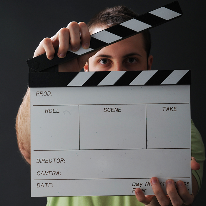 Student with film clapboard