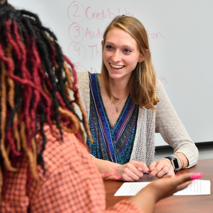 student assisting client at the center