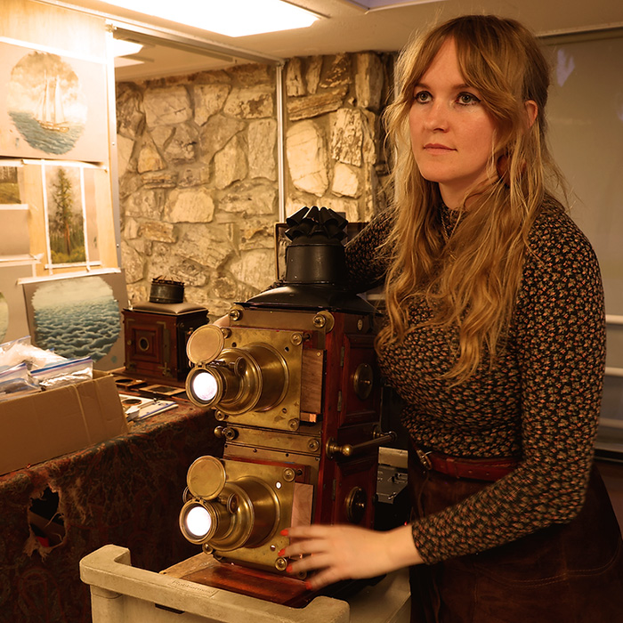 Artist Melissa Ferrari operating her magic lantern