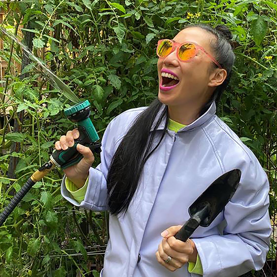 Artist with gardening tools to promote Gardening for the Future program