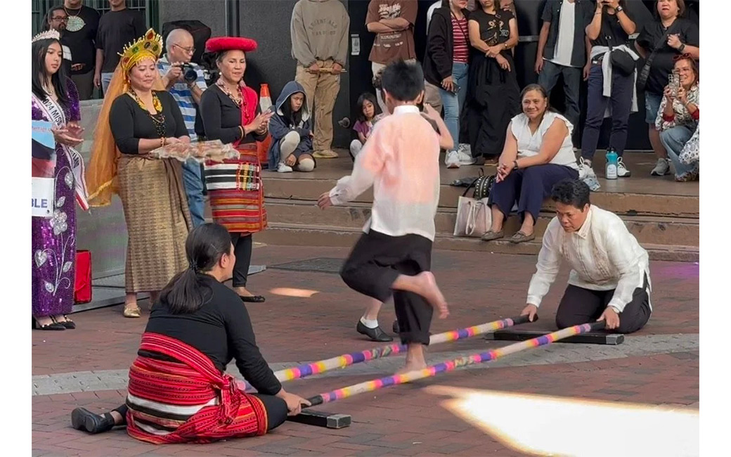 Dancing the tinikling at the Filipino Festival