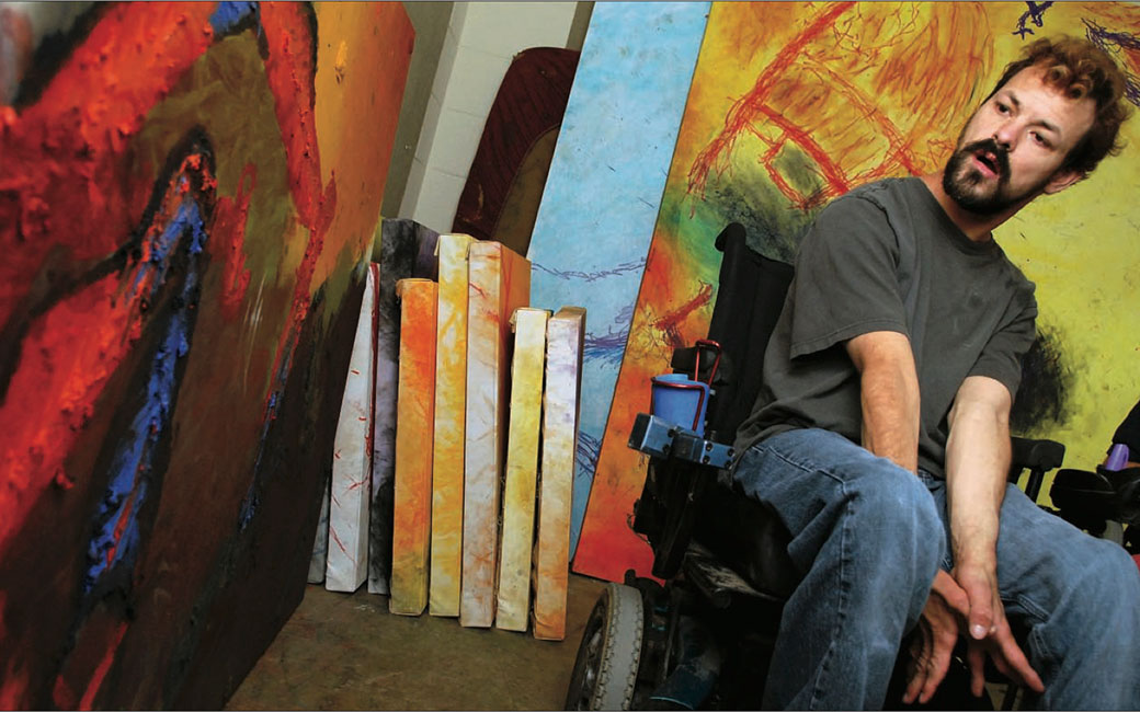 Video of Photograph of Dan Keplinger in front of canvas paintings