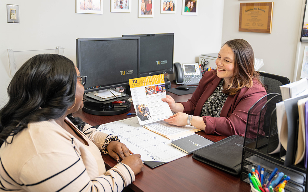 An advisor meets with a student