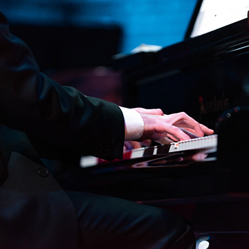 Close up on hands playing piano
