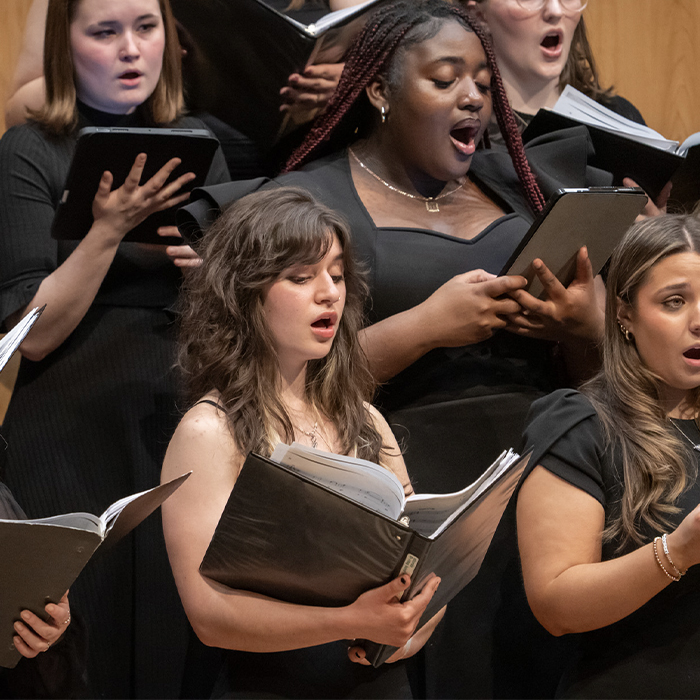 Students in the TU Choir perform on stage