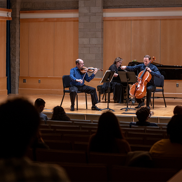 Faculty playing music on stage