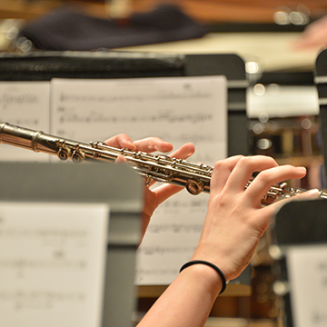 Close up on a musician playing a flute
