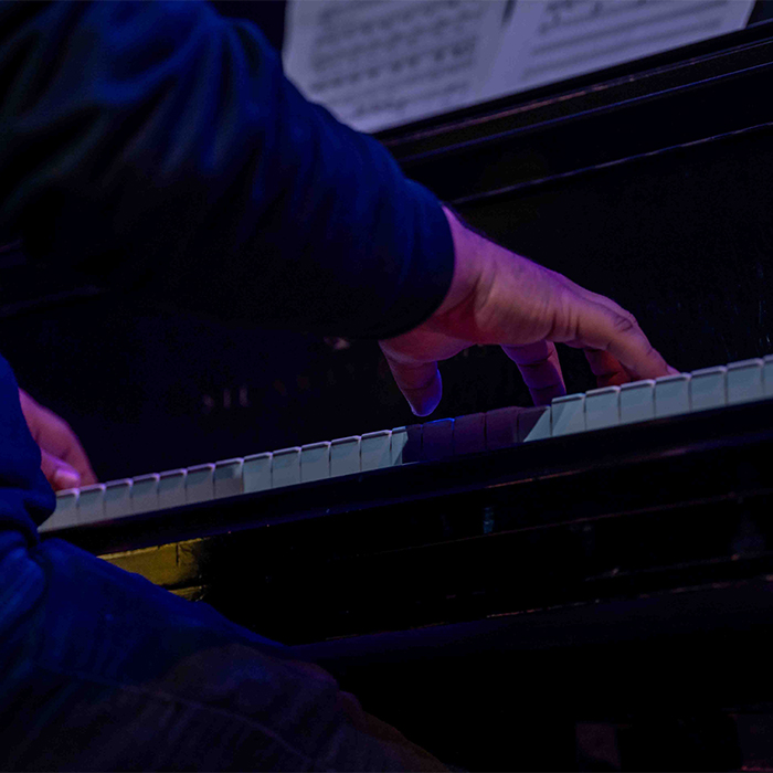 Close up on hands playing a piano