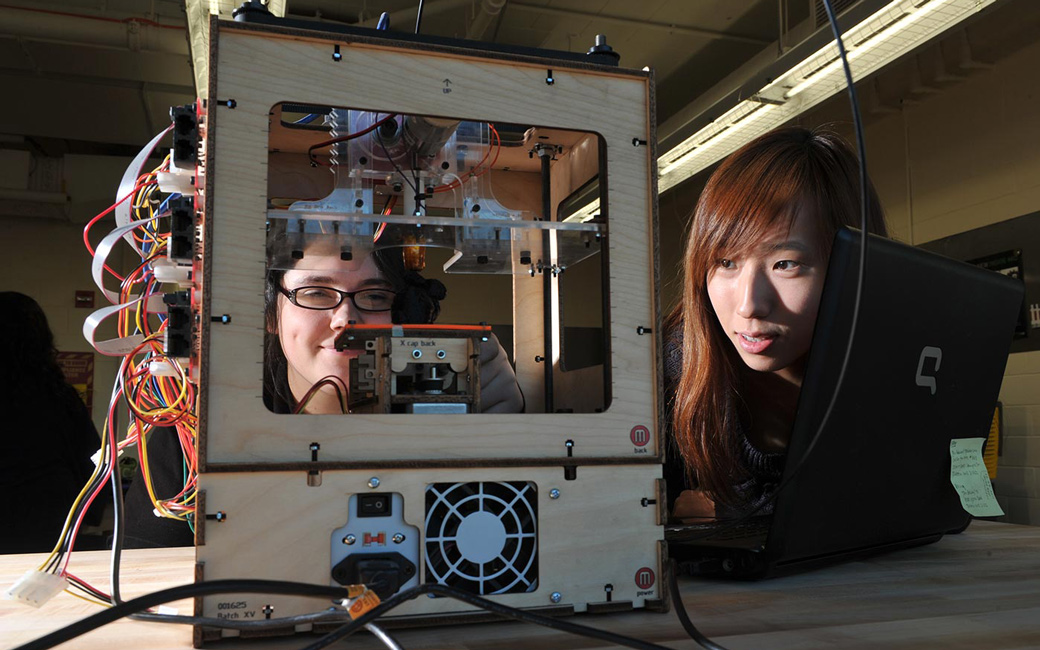 close up of 2 students printing a 3D object