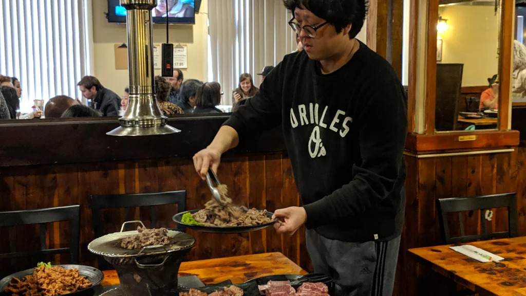 Suk Jeong, Owner and Manager of Jong Kak, preparing food for Asia North's 2019 Restaurant Tour.
